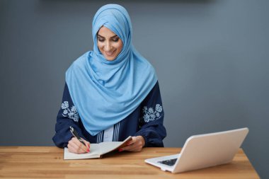 Muslim female student learning at home