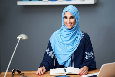 Muslim female student learning at home
