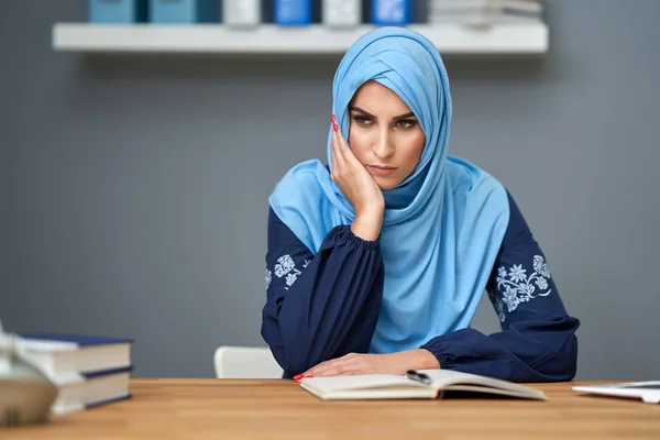 Unhappy muslim female student learning at home — 스톡 사진