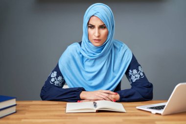 Muslim female student learning at home