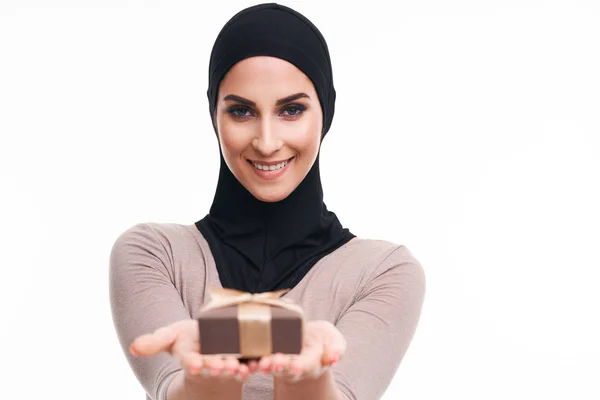 Muslim woman with present over white background — Stock Photo, Image