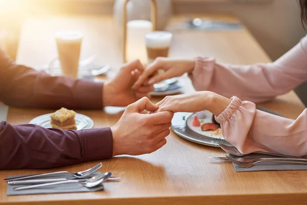 Jong koppel genieten van koffie en gebak in café — Stockfoto