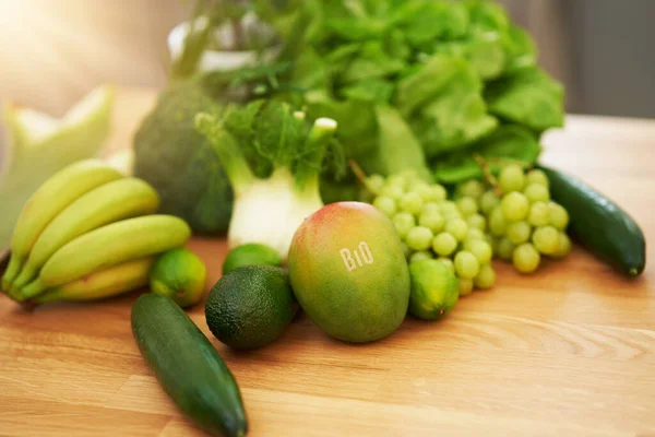 Frutas e legumes verdes frescos no balcão de madeira — Fotografia de Stock