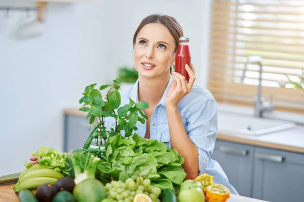 Mujer adulta saludable con comida verde en la cocina —  Fotos de Stock