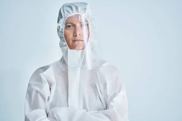 Woman in bio-hazard suit and face shield on white background. — Stock Photo, Image