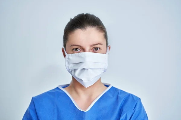Close up portrait of female medical doctor or nurse wearing protective mask — Stock Photo, Image