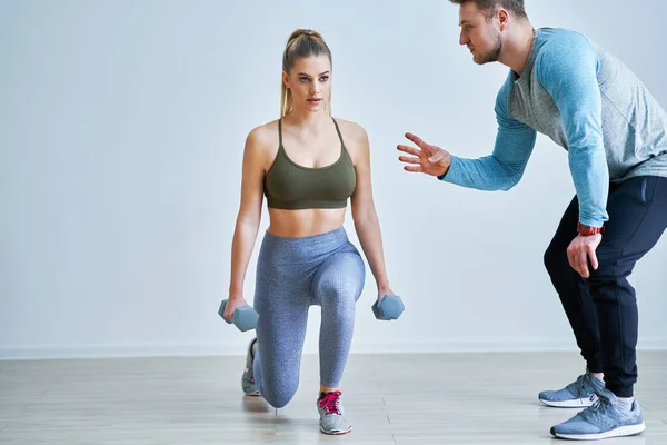 Woman with her personal fitness trainer — Stock Photo, Image