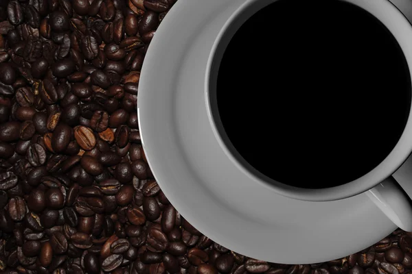 White coffee cup with saucer and a real world picture of roasted coffee — Stock Photo, Image