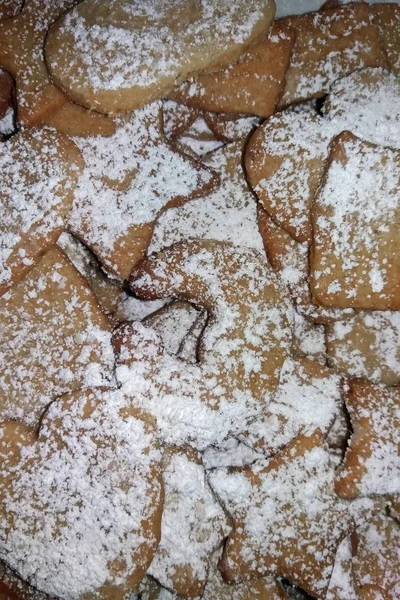 home-baked Christmas biscuits with a lot of powdered sugar