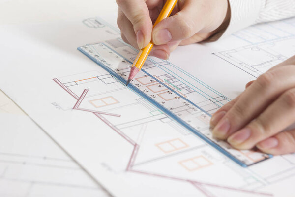 Architects working on blueprint, real estate project. Architect workplace - architectural project, blueprints, ruler, calculator, laptop and divider compass. Construction concept. Engineering tools.