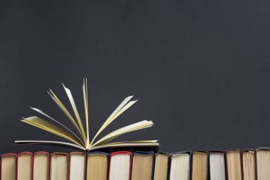 Açık kitap, ahşap masadaki ciltli kitaplar. Okula dönelim. Boşluğu kopyala