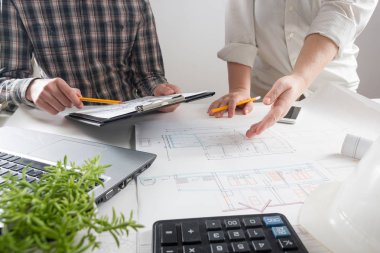 Mimarlar Blueprint, gayrimenkul projesi üzerinde çalışıyor. Mimar işyeri - mimari proje, planları, cetvel, hesap makinesi, laptop ve bölücü pusula. İnşaat kavramı. Mühendislik araçları.