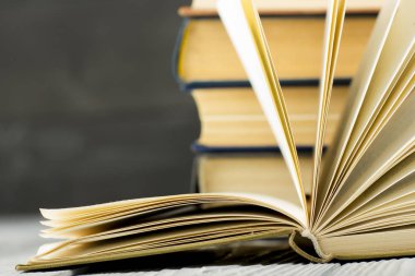 Açık kitap, ahşap masadaki ciltli kitaplar. Okula dönelim. Boşluğu kopyala