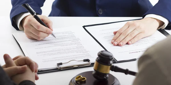 Hands of wife, husband signing decree of divorce, dissolution, canceling marriage, legal separation documents, filing divorce papers or premarital agreement prepared by lawyer. Wedding ring — Stock Photo, Image