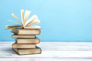 Açık kitap, ahşap masadaki ciltli kitaplar. Okula dönelim. Boşluğu kopyala