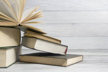 Açık kitap, ahşap masadaki ciltli kitaplar. Okula dönelim. Boşluğu kopyala
