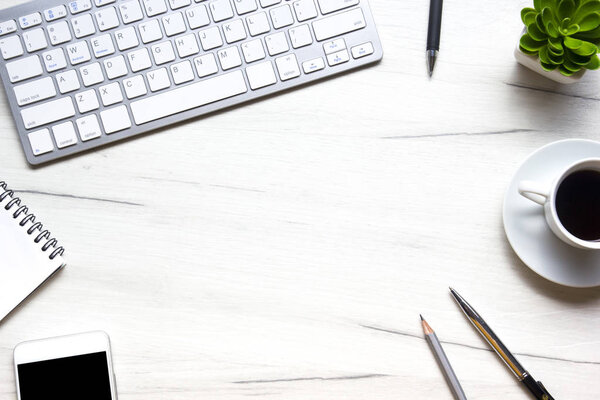 Белый стол офис с ноутбуком, смартфоном и другими рабочими принадлежностями с чашкой кофе. Вид сверху с местом для копирования для ввода текста. Дизайнерское рабочее место на письменном столе