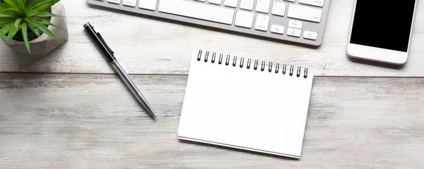 White desk office with laptop, smartphone and other work supplies with cup of coffee. Top view with copy space for input the text. Designer workspace on desk table essential elements on flat lay