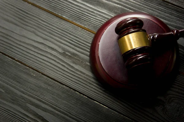 Law concept - Open law book with a wooden judges gavel on table in a courtroom or law enforcement office isolated on white background. Copy space for text