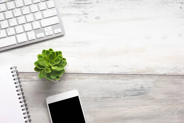 White desk office with laptop, smartphone and other work supplies with cup of coffee. Top view with copy space for input the text. Designer workspace on desk table essential elements on flat lay