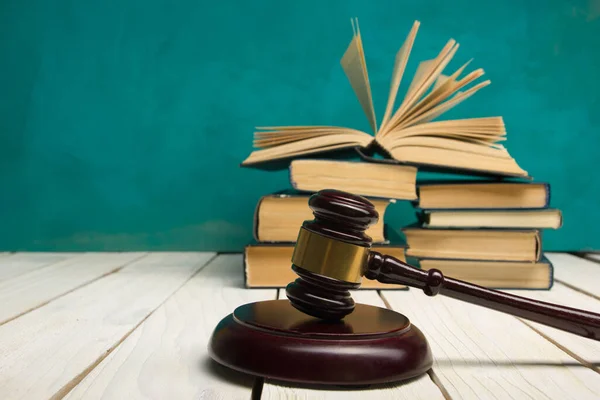 Law concept - Open law book with a wooden judges gavel on table in a courtroom or law enforcement office isolated on white background. Copy space for text — Stock Photo, Image