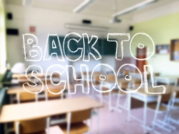 A chalk lettering with a blurred classroom