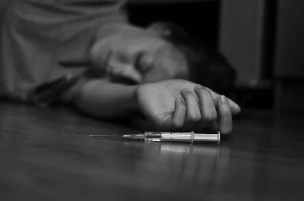 Drug addict on floor — Stock Photo, Image