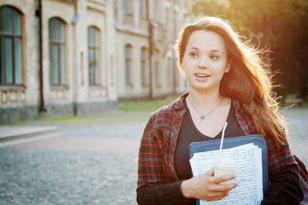 student near university building after writing an exam