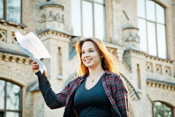 student near university building after writing an exam