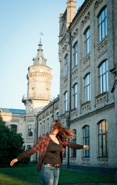 student near university building after writing an exam