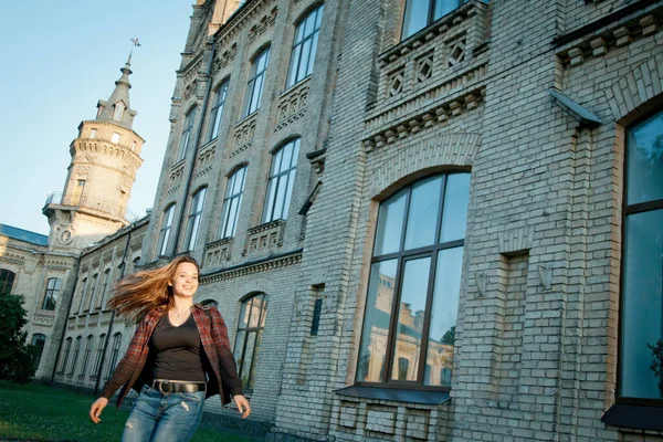 student near university building after writing an exam