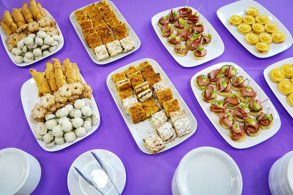 Canapes Und Kekse Liegen Auf Weißen Tellern Auf Einer Lila — Stockfoto
