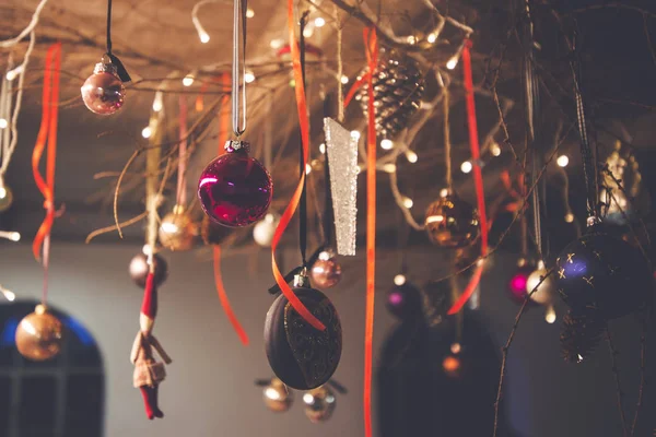 クリスマス装飾クリスマスのつまらないものとリボンで農村の納屋の天井からぶら下がっています — ストック写真