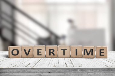 Fazla mesai sözcüğü tahta bloklarla yazılıyor