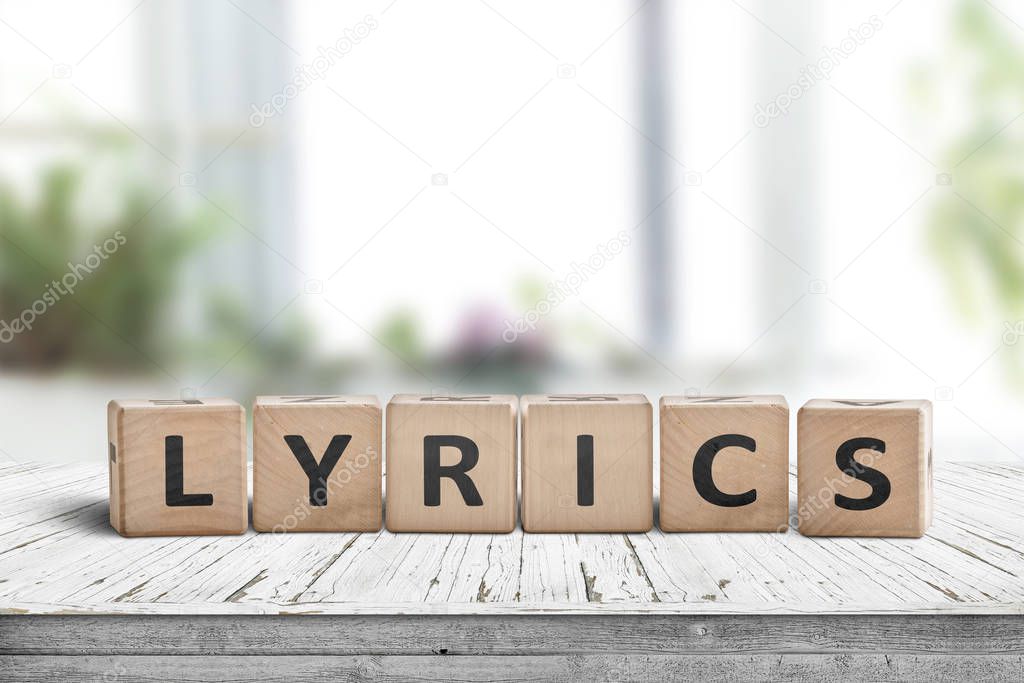 Lyrics sign on a table in a bright room