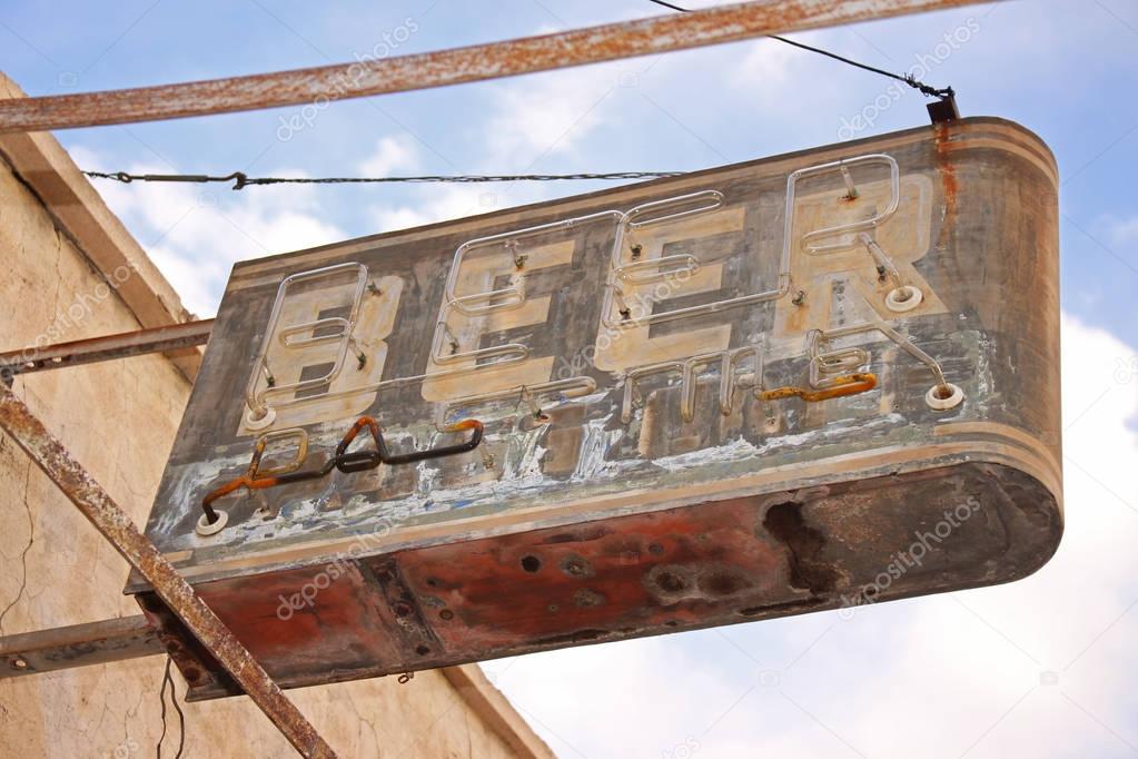 A beer sign at a long abandoned bar in the American Southwest.