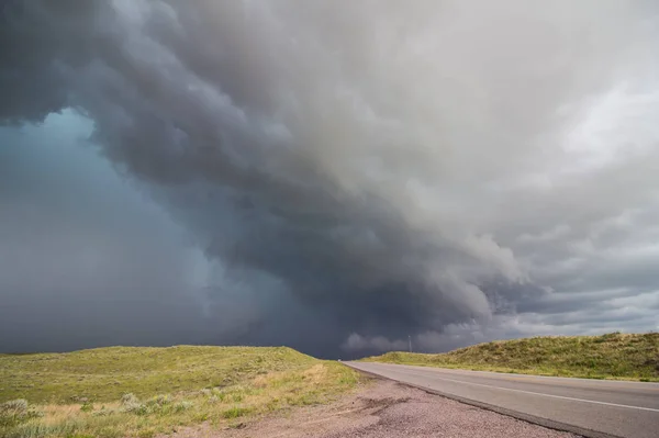 A dangerous thunderstorm approaches a rural highway in Nebraska.