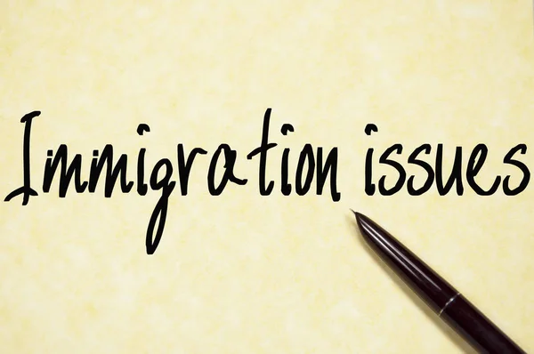 Immigration issues text write on paper — Stock Photo, Image
