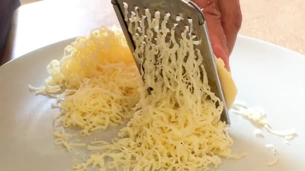 Rasping cheese with a grater — Stock Video