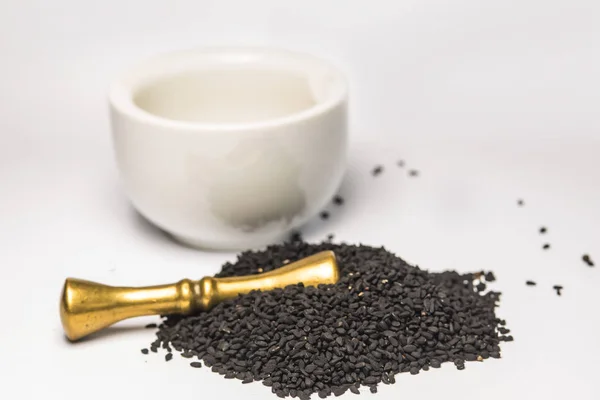 Black caraway seeds with mortar — Stock Photo, Image