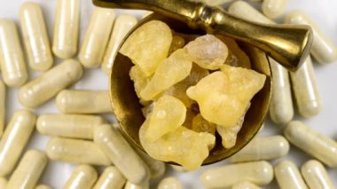 Olibanum, pieces in a mortar and Olibanum capsules