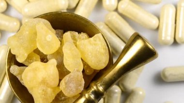 Olibanum, pieces in a mortar and Olibanum capsules