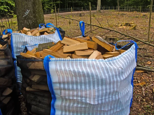 freshly chopped fuel-wood in a bag in a forest