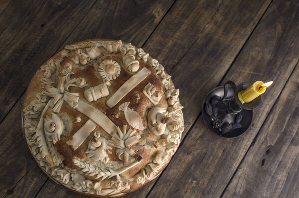 Festive baked bread on wooden background.