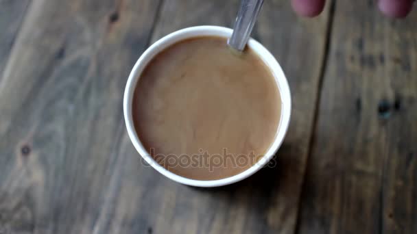 Hand using spoon to stir  black coffee — Stock Video