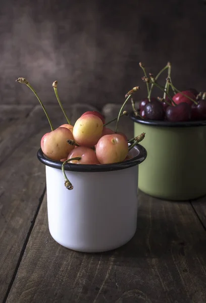 Freshly picked cherries on dark wooden table — Stock Photo, Image