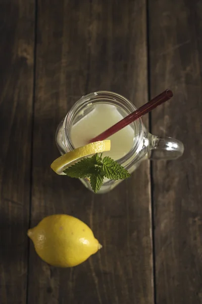 Lemonade glass jar with lemon wedges and straw — Stock Photo, Image