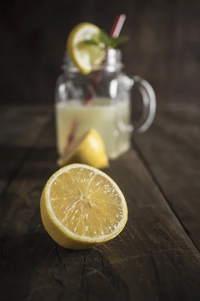 Lemonade glass jar with lemon wedges and straw — Stock Photo, Image