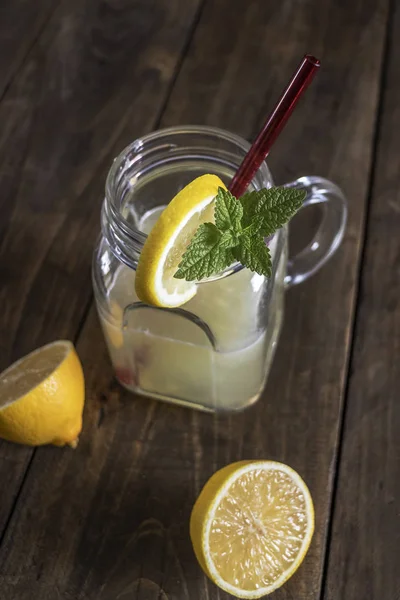 Lemonade glass jar with lemon wedges and straw — Stock Photo, Image