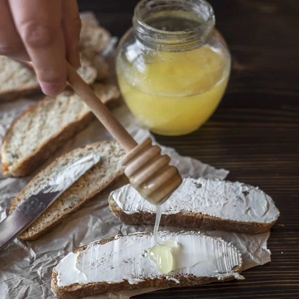 Slices of toast bread with butter on wooden table — Stock Photo, Image